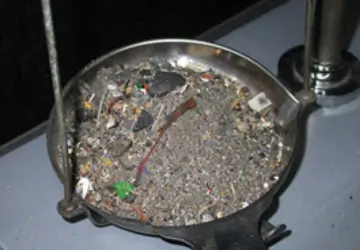 Low-grade precious metal sweeps and filings in a refining dish